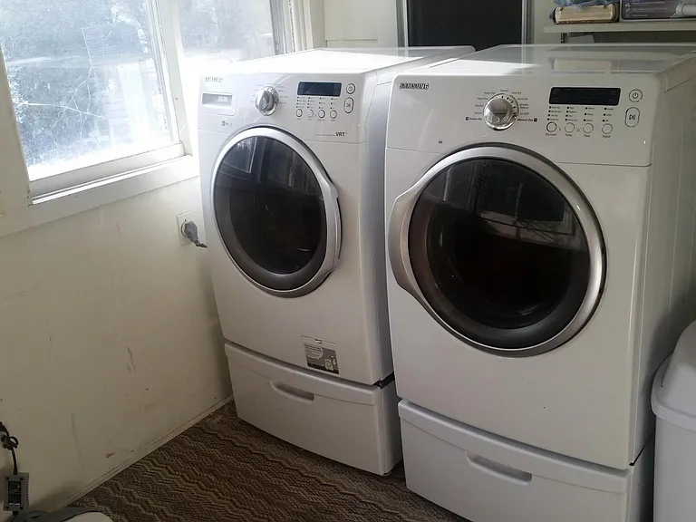 Sunny Laundry Room with Front-Loading Washer and Dryer