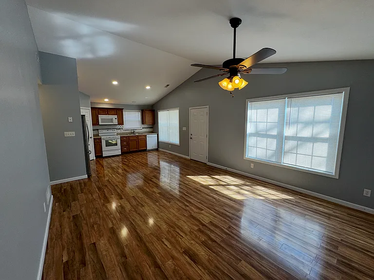 View of the main living area with large double windows in both the kitchen and living room that light this place up during the day helping you save money on electric with natural sunlight.