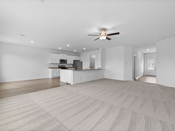 Open-concept layout of the Osage plan, connecting the dining, kitchen, and living room.