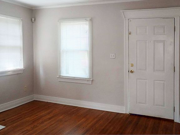 Living room -- abundant natural light and lovely wood floors.