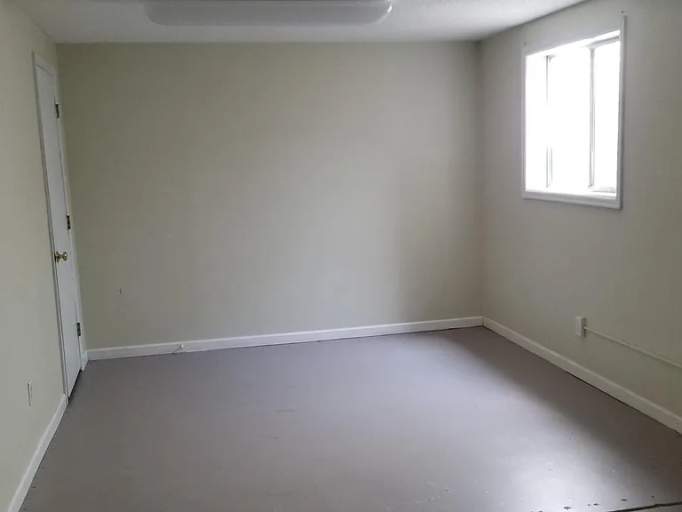 Downstairs home office with large window.