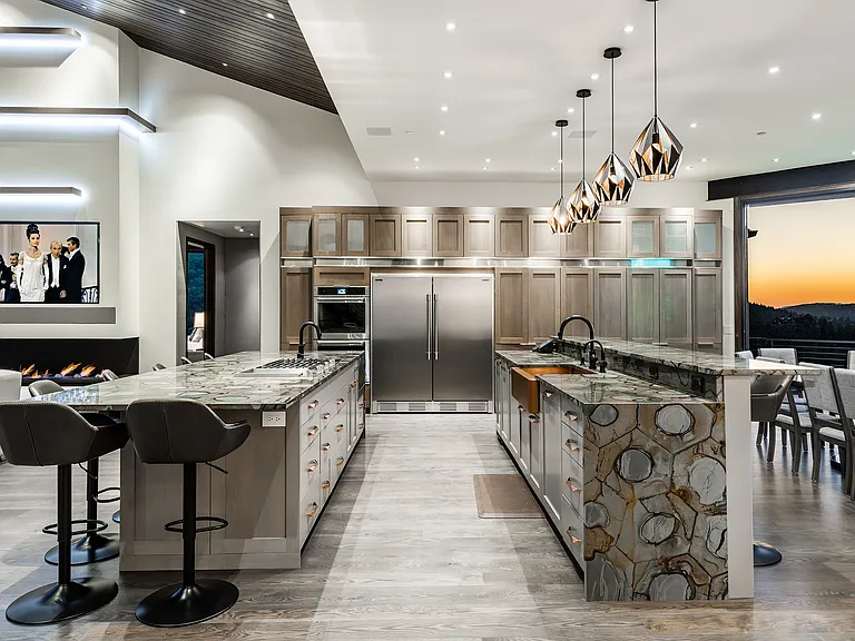 Double islands, one with cook top, one with sink and TWO dishwashers. Full size built in fridge and freezer and ample cabinetry