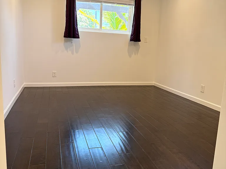 Primary bedroom featuring two windows, dimmable recessed LED lighting, a ceiling fan, a walk-in closet, and an en-suite bathroom.