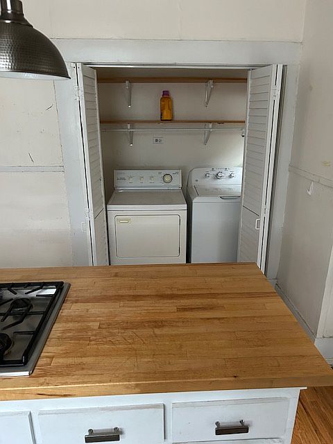utility area with washer and dryer off kitchen.
