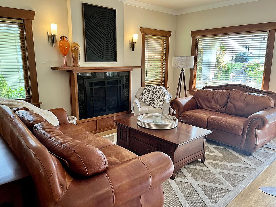 Living room with cozy leather couches & gas fireplace