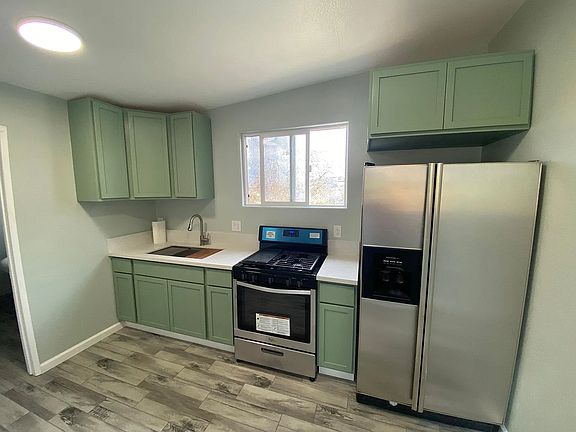 Kitchen - New tile floors, maple cabinets, quartz countertops and stainless steel appliances