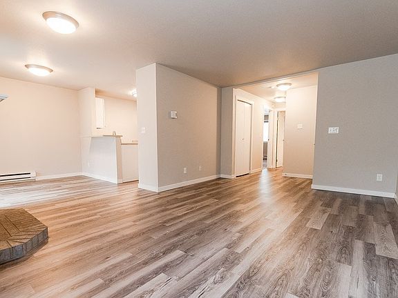 Puyallup Apartments - Cambridge on Seventh Apartments - Living Room, Fireplace, Dining Room, Kitchen, and Entryway