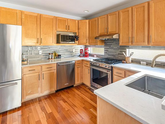 Recently upgraded kitchen with top of the line stainless steel Kitchen Aid appliances, gas range, ultra quiet dishwasher, and plenty of storage.