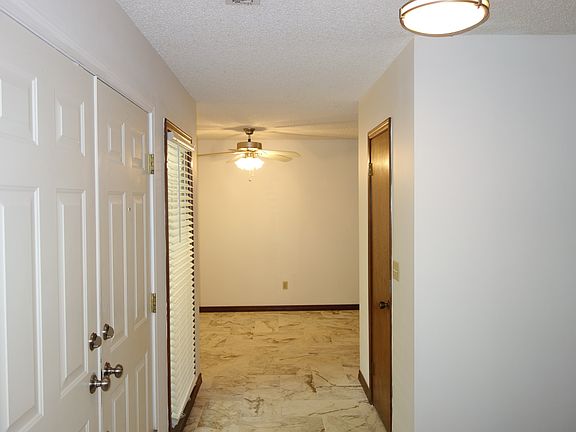 Tiled Entryway looking towards hallway to kitchen. On Right, Door to Large storage closet.