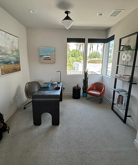 Large primary bedroom sitting area used as an office with great views