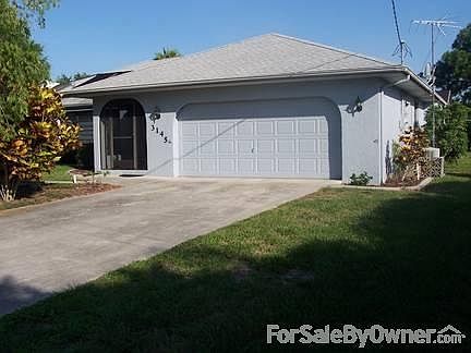 Garage with Automatic Door Opener. : Garage complete with work bench, door to Laundry room and exter
