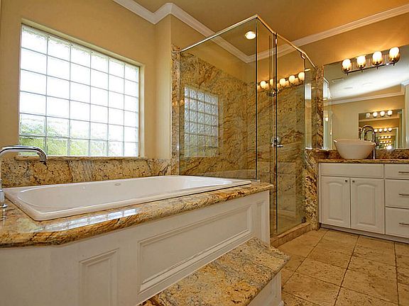 LUXURIOUS STAND UP SHOWER WITH SEATING -BLOCK GLASS ALLOWS IN NATURAL LIGHT/UNDER THE SINK STORAGE FOR TOILETRIES