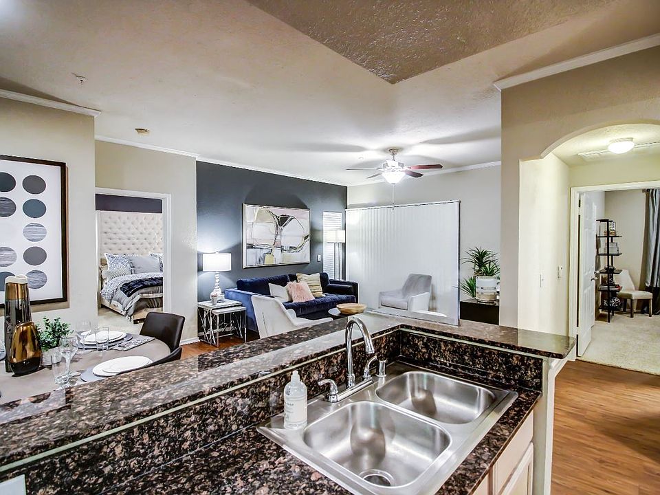 Kitchen are and living room with cozy dining nook, double sink and hardwood style flooring