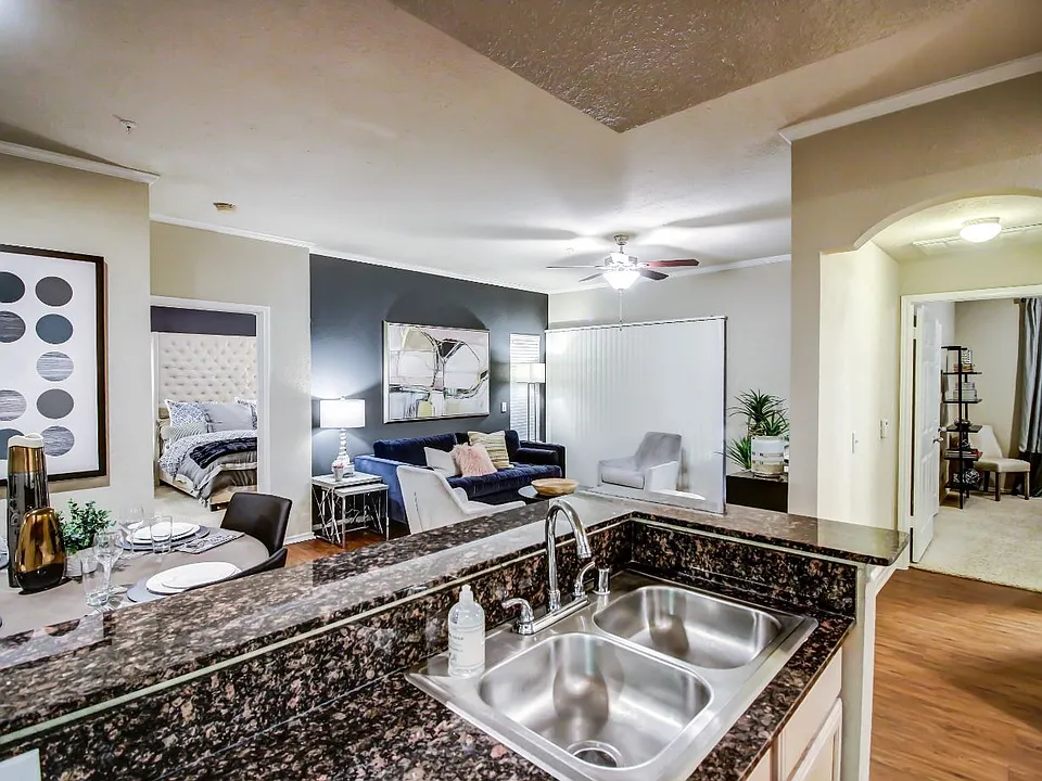 Kitchen are and living room with cozy dining nook, double sink and hardwood style flooring