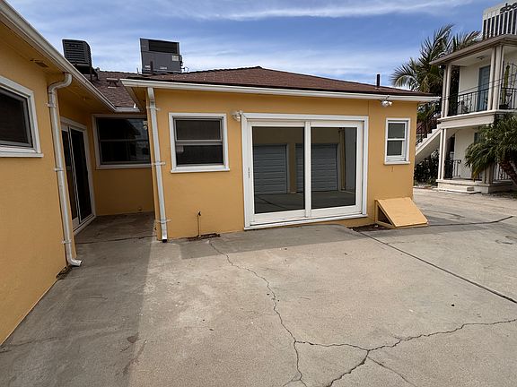 Driveway and patio access to the laundry, dining room, and one of the three bedrooms.