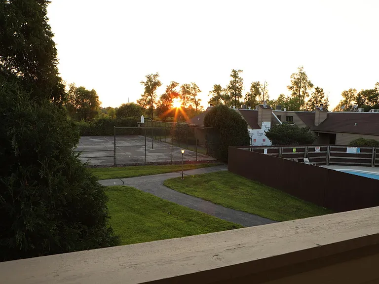 Looking out from front porch -view of Tennis, Basketball courts and Pool.