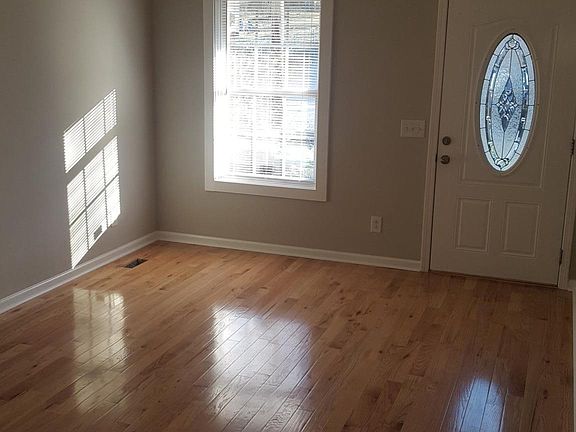 Livingroom with high ceilings and natural light that leads i