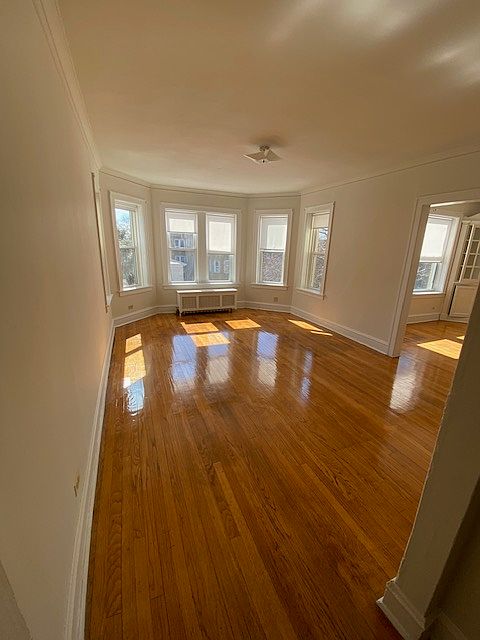 Spacious Living room and Beautiful entry to formal Dining room with built in hutches. Vintage charm, natural sunlight