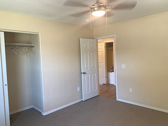 2nd bedroom, with large closet and ceiling fan with light. Berber carpeting.