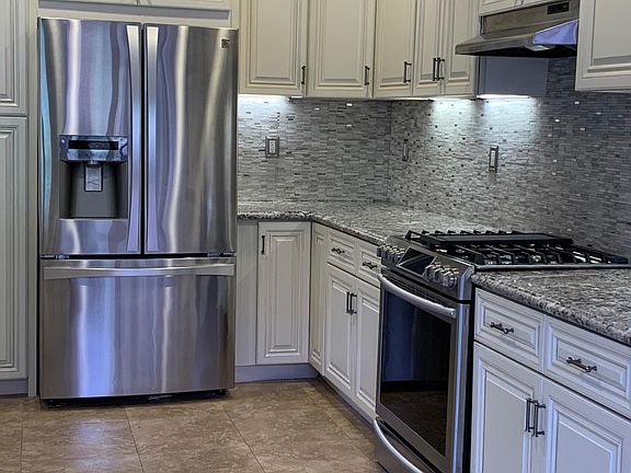 Custom backsplash surrounds the custom counters and cabinets