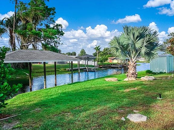 Backyard, boat house, canal, palm tree
