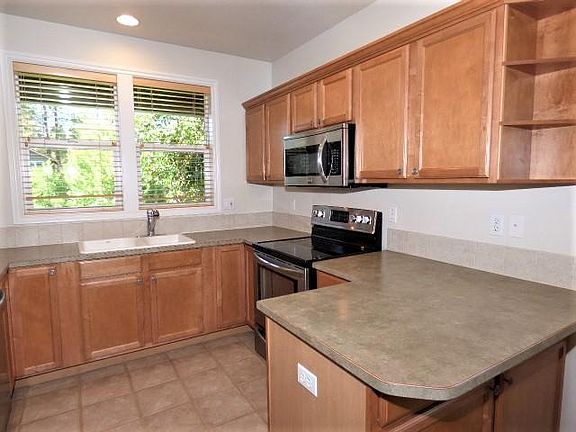 Nice Maple Wood Kitchen Cabinet's with Tile Flooring.