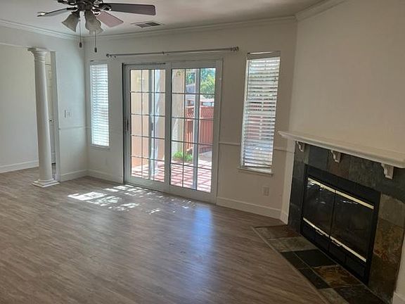 Living room with sliders to side yard and fireplace
