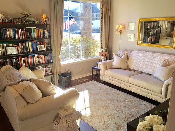 Cozy living room overlooking mature landscaping.