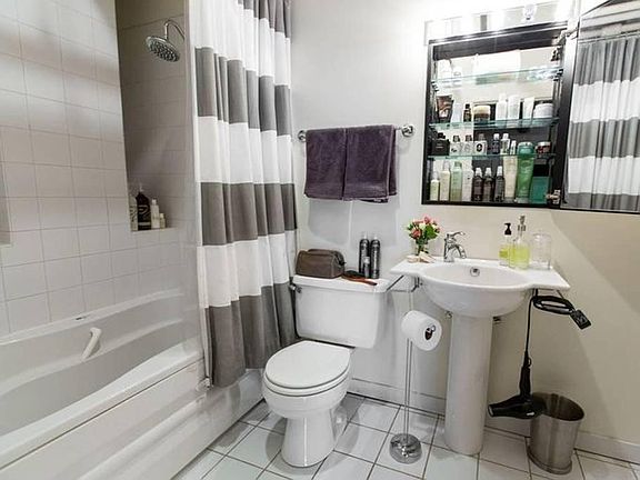Bathroom with Shower + Whirlpool Tub. Medicine Cabinet Mirror.