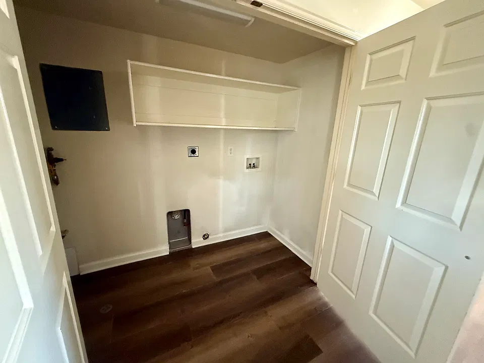 laundry hook ups with shelf is in a large closet off from the kitchen on the main level
