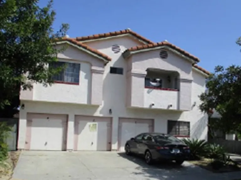 Street view of complex. Unit garage is Center Space. Main gate entrance to right.