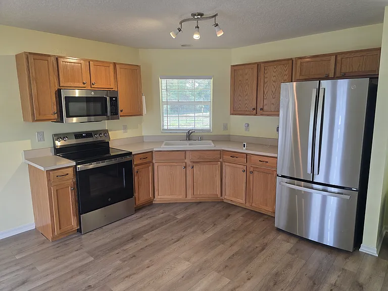 Kitchen with new stove and microwave