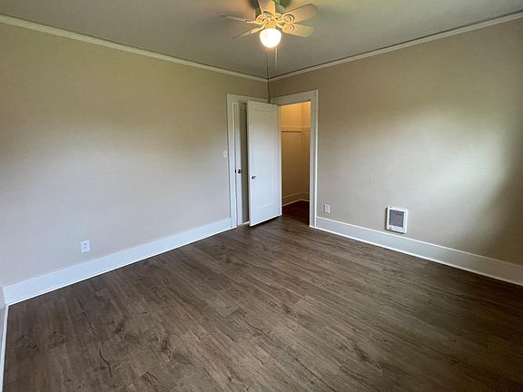 Downstairs bedroom with luxury vinyl plank floors and small walk in closet