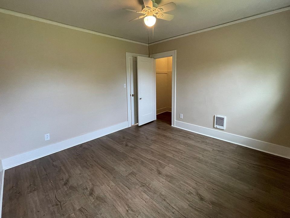 Downstairs bedroom with luxury vinyl plank floors and small walk in closet