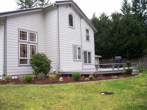 View of back exterior and large deck