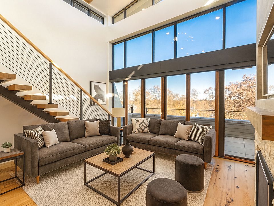 Living Room - Floor to ceiling windows, panoramic views, automatic blinds, double-sided Gas FP, Hickory wood floors, and more! (Virtually Staged)