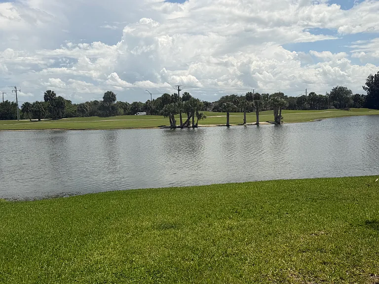 Enjoy STUNNING lake & golf course views from the living room & Primary Bedroom!