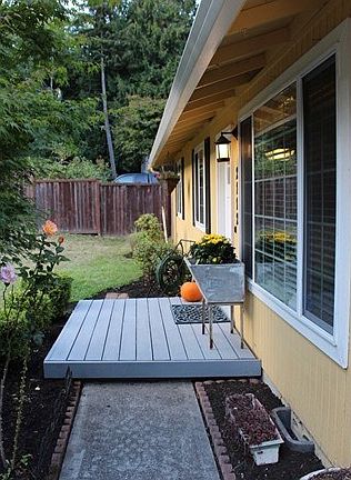 This shows the front deck with access to craftsman style front door.