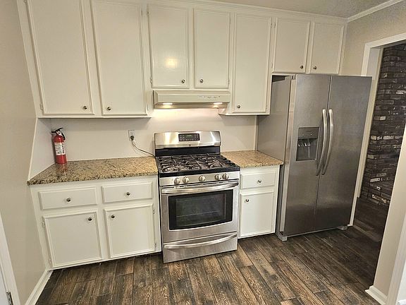 Kitchen with granite countertops and gas stove