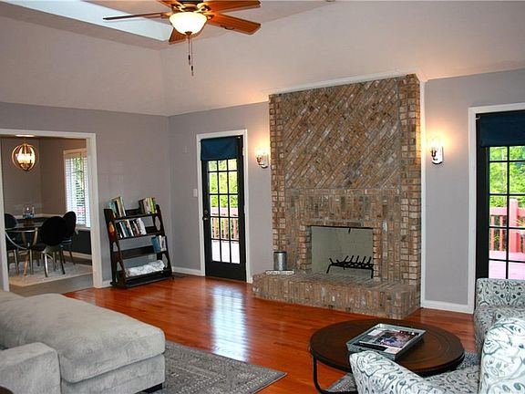 Wood burning, floor to ceiling masonry fireplace with hearth.