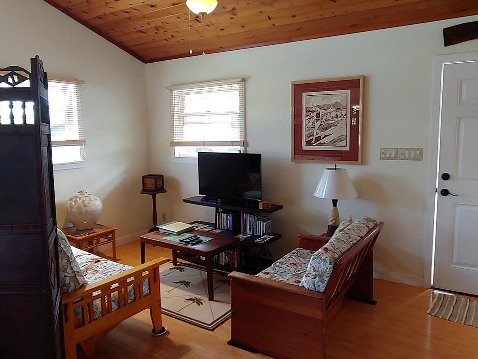 Living room/seating area with TV, DVD player and cable TV. Hardwood floors.
