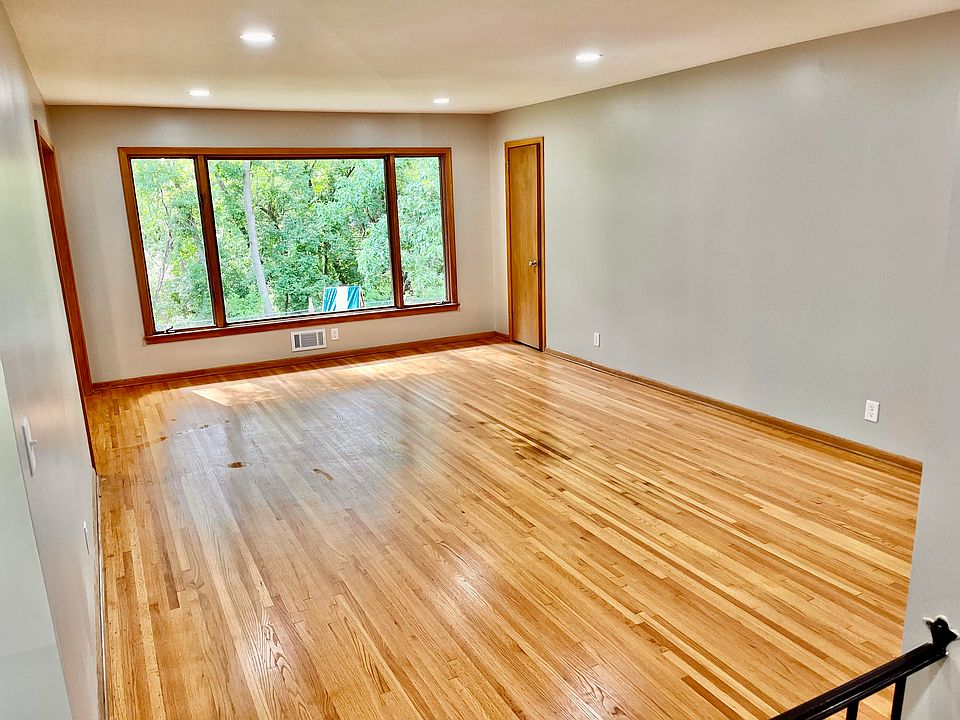 Main floor living room with refinished original hardwood floors and a view of the backyard.