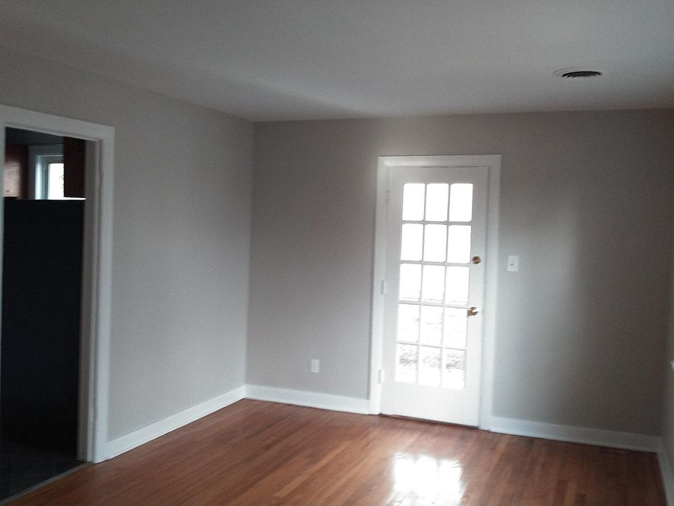 Bright living room leads to kitchen and screened porch.