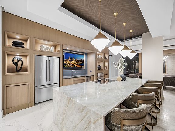 Entertaining kitchen and social lounge featuring a suite of premium appliances