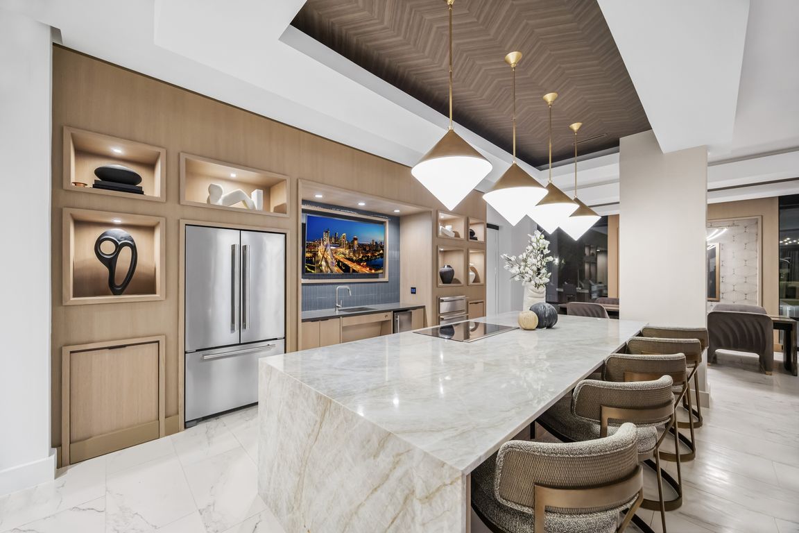 Entertaining kitchen and social lounge featuring a suite of premium appliances