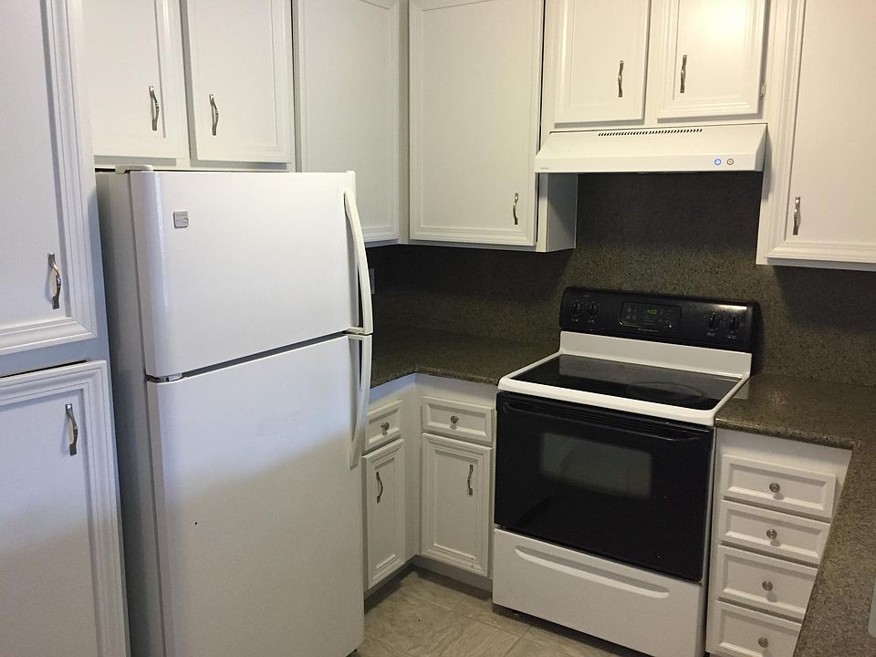 Granite counters and tile floor in kitchen