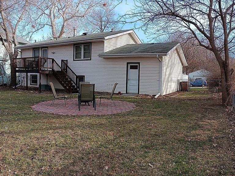 Fenced backyard with fire pit, new deck and grill.