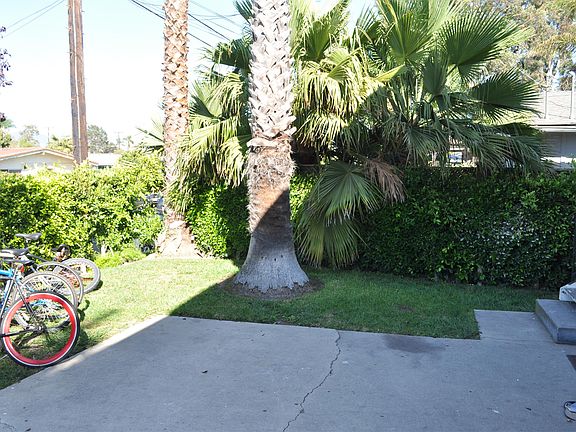 Bike racks and small front yard to the left of the driveway.