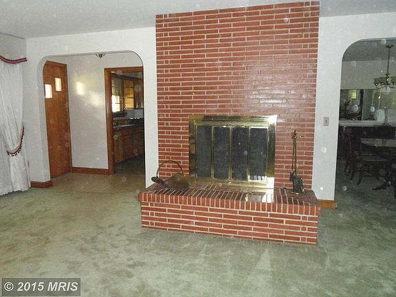 Brick, wood-burning fireplace in living room