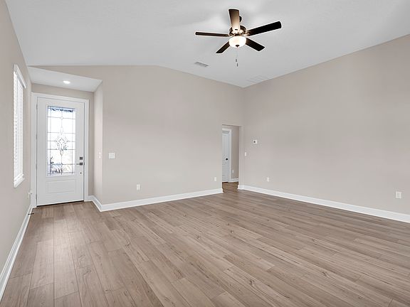 The spacious entryway warmly welcomes guests with its inviting and open design.